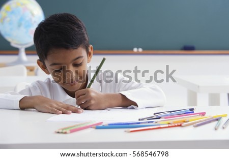 boy concentrates on schoolwork