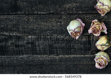 white pink dried roses on wooden table. Valentines Day concept