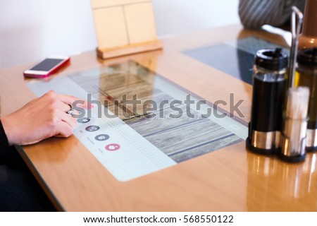 Modern multitouch-table in restaurant Royalty-Free Stock Photo #568550122