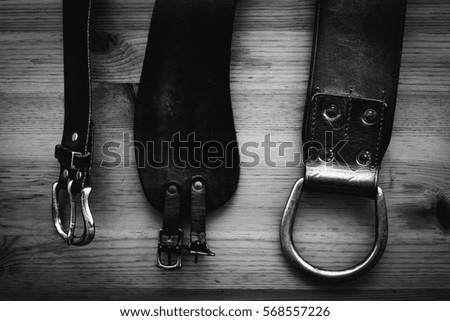 leather belts in wooden background 