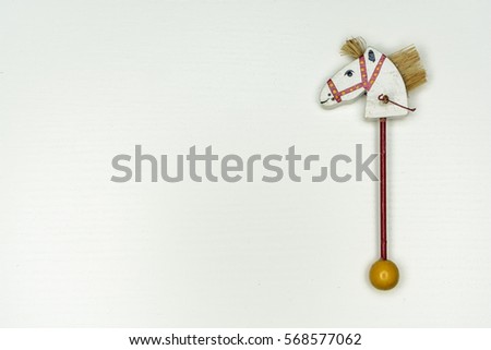 white wood horse head on stick vintage toy isolated on white background 