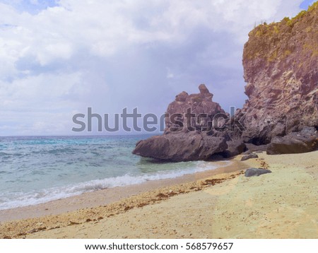 Seaside scene with mountain. Aqua blue sea water and yellow sand beach. Tropical island toned photo. Exotic seashore in rainy season. Blue sky with white clouds. Summer holiday place banner template
