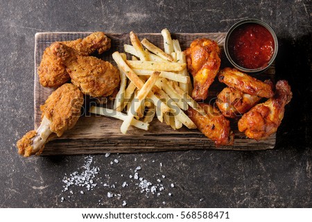 Fried chicken legs with french fries Royalty-Free Stock Photo #568588471