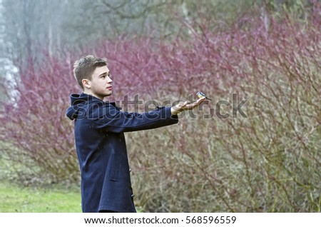 The guy in the forest feeding birds in spring