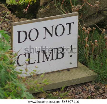 Hand Made Wooden "Do Not Climb!" Sign in a Country Cottage Garden in Rural Devon, England, UK