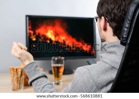 agitated man watching (on TV) wildfire