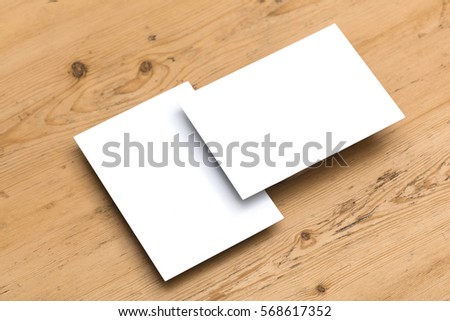 Blank white postcard on a wooden background