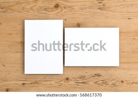 Blank white postcard on a wooden background