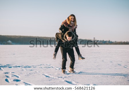 winter couple in love, walk on frozen lake