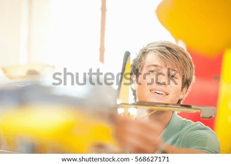 Man working on model airplane