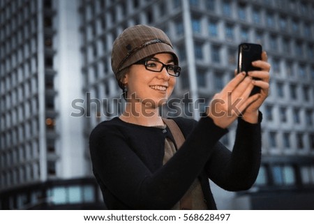 Woman taking picture with cell phone