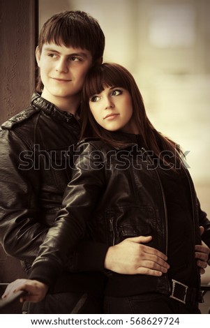 Happy young couple in love embracing on city street Stylish fashion model outdoor 