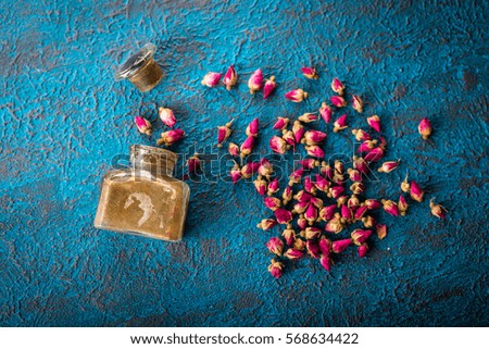 Dry tea rose buds on dark blue background