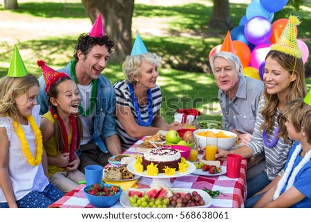 Happy family celebrating a birthday in the park