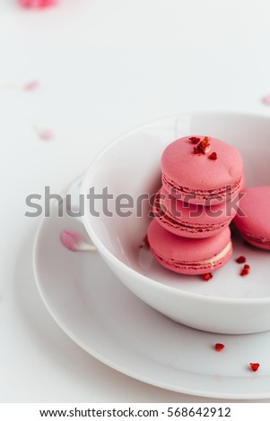 Strawberry Macarons Stacked in White Bowl on White Table