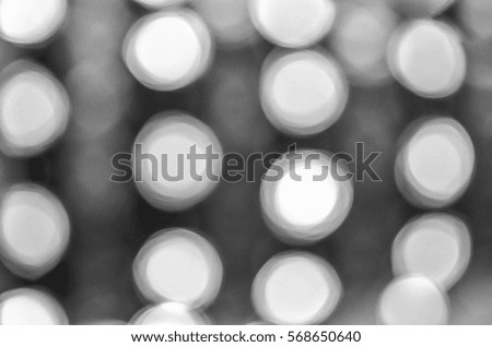 Soft colorful bokeh background. Luminous garlands of electric lights. Copy space to add text.  Blurry abstraction. Black & white. Dark night. Festive party in city. Defocus effect.