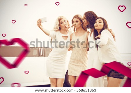 Well dressed women taking selfie against hearts