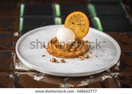 Apple pie and ice cream - tasty and healthy. Dessert close-up on a dark background.