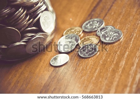 russian coins in a glass jar and some various coins on the table for backgrounds and illustrations