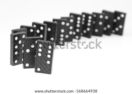 Dominoes standing on plain background