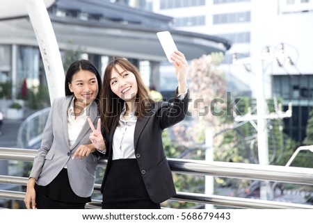 Two business asian woman, 2 girl selfie and smiling together.