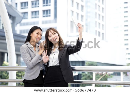 Two business asian woman, 2 girl selfie and smiling together.