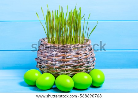 Fresh grass and easter eggs in green pastel color