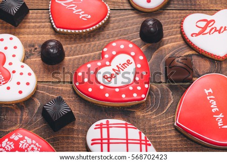 Heart-shaped biscuits for Valentine's Day. Gingerbread Valentine with chocolate on wooden background