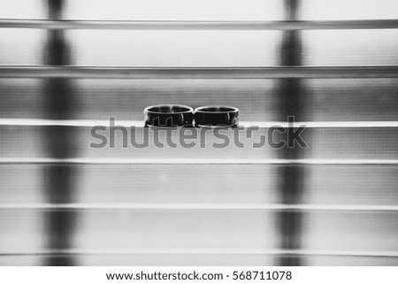 The wedding rings  stand on the louver