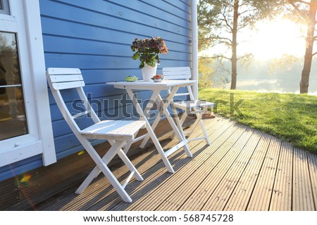 summer terrace, table and chairs Royalty-Free Stock Photo #568745728