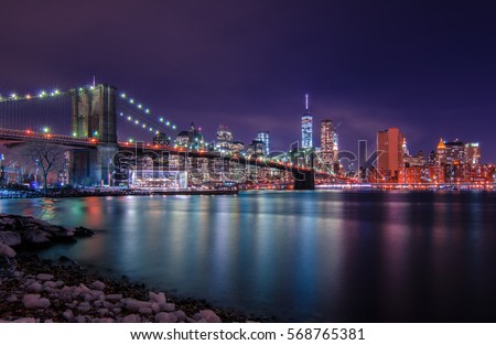 Iconic view of Manhattan skyline and a Brooklyn bridge at night. New York, USA