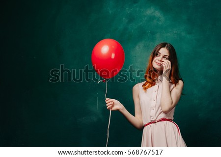 A girl holding a balloon, festive mood, balloons, happy woman with a balloon