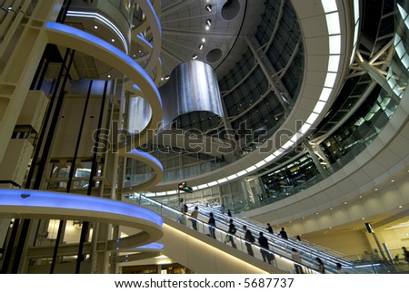 futuristic interior with moving escalator and many people on it, Tokyo Japan Royalty-Free Stock Photo #5687737