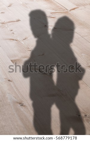 Depressed couple standing back to back against bleached wooden planks background
