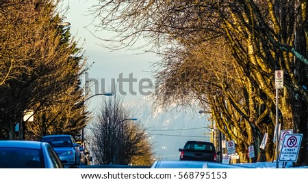 Zoom View on the Cars, Trees & Mountains in Vancouver - Streets of Vancouver at Wintertime - CANADA