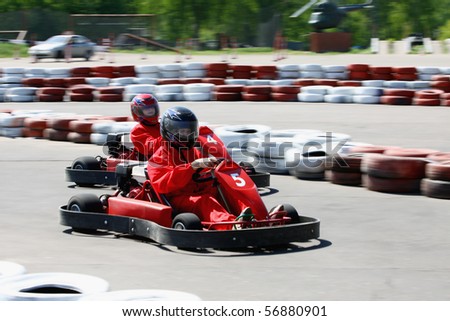 Go cart racers struggling on circuit Royalty-Free Stock Photo #56880901