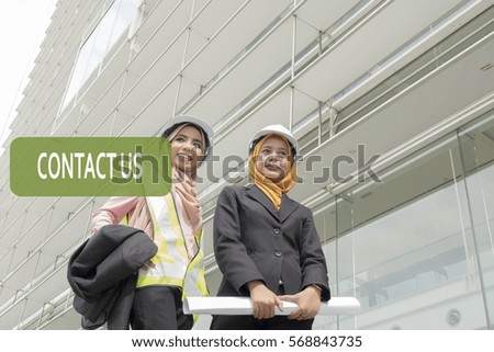 Smiling Asian business woman with text- Contact Us