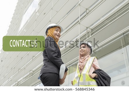 Smiling Asian business woman with text- Contact Us