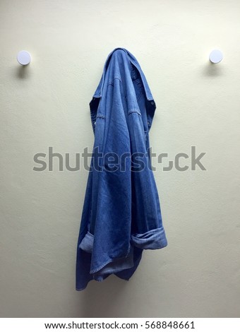 denim jacket is hanged on the wall Royalty-Free Stock Photo #568848661