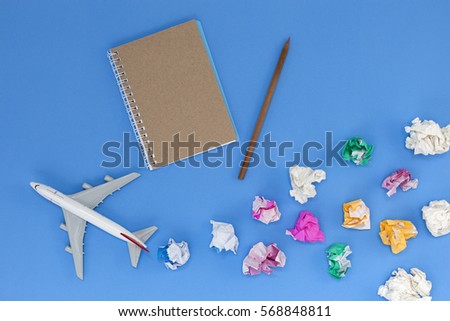 Airplane model with colorful blank paper note on blue background, picture for add text message or used background, website, travel and tour background