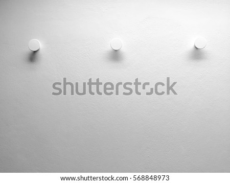 modern three hooks on the white wall Royalty-Free Stock Photo #568848973
