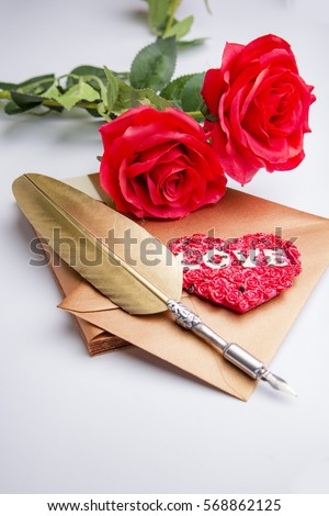 Valentine's Day: Love letter with golden quill, heart symbol as a seal and two red roses, white background