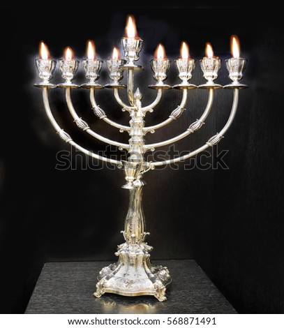 silver Chanukah menorah with olive oil flames