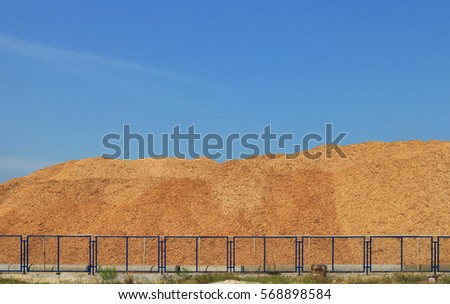 Wood Chip Mountain under Clear Sky