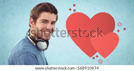 Happy man with headphones against blue background
