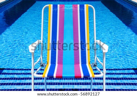 a deckchair in a swimming pool in the summer