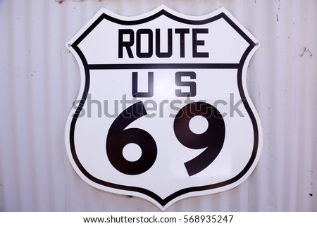 Route US 69 sign on a corrugated metal background.