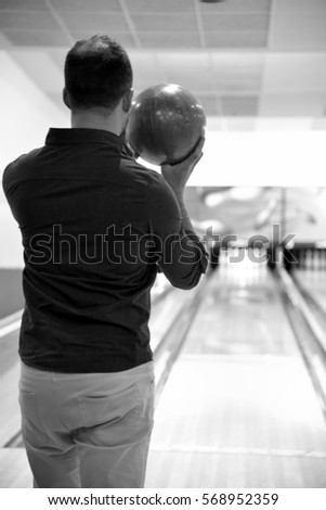 man preparing to throw bowling ball 