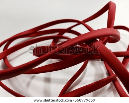 Red cable on white table background Royalty-Free Stock Photo #568979659