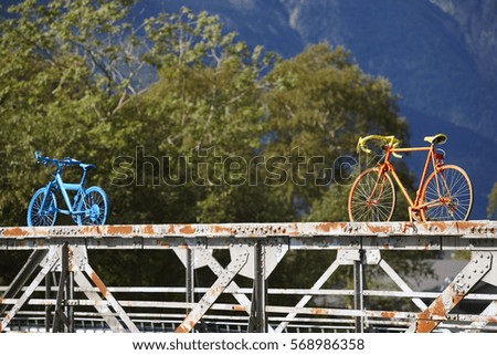 Painted bikes over a rusty bridge. Odda village. Norway tourism. Horizontal